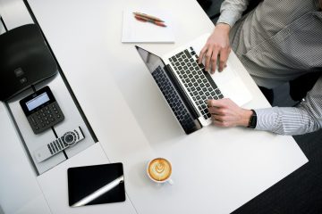 A business professional working on tax documents at a desk.