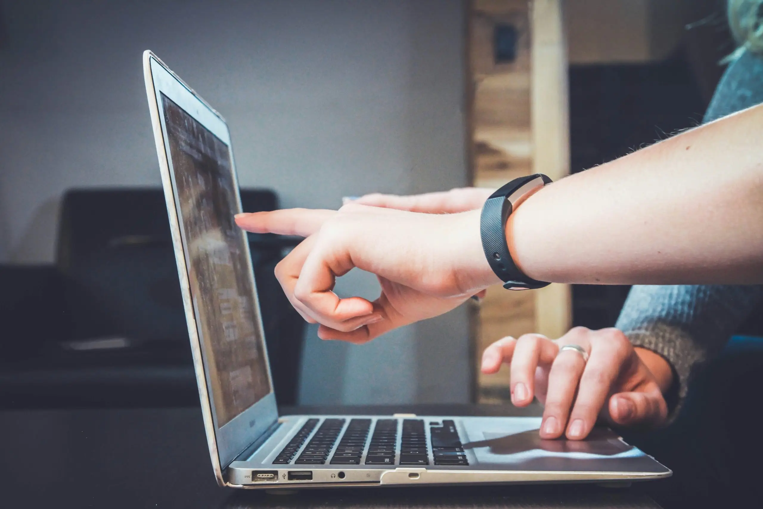 A person using a laptop for online tax management.