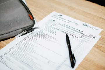 A tax document with a pen on a desk.