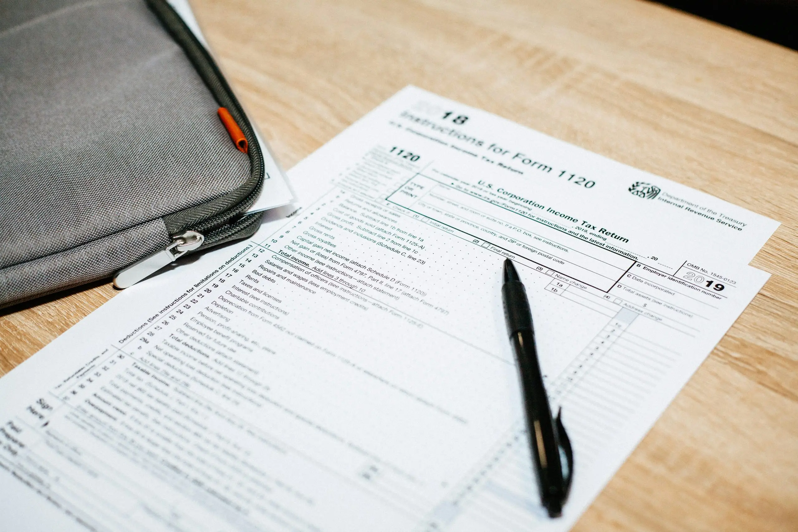 A tax document with a pen on a desk.