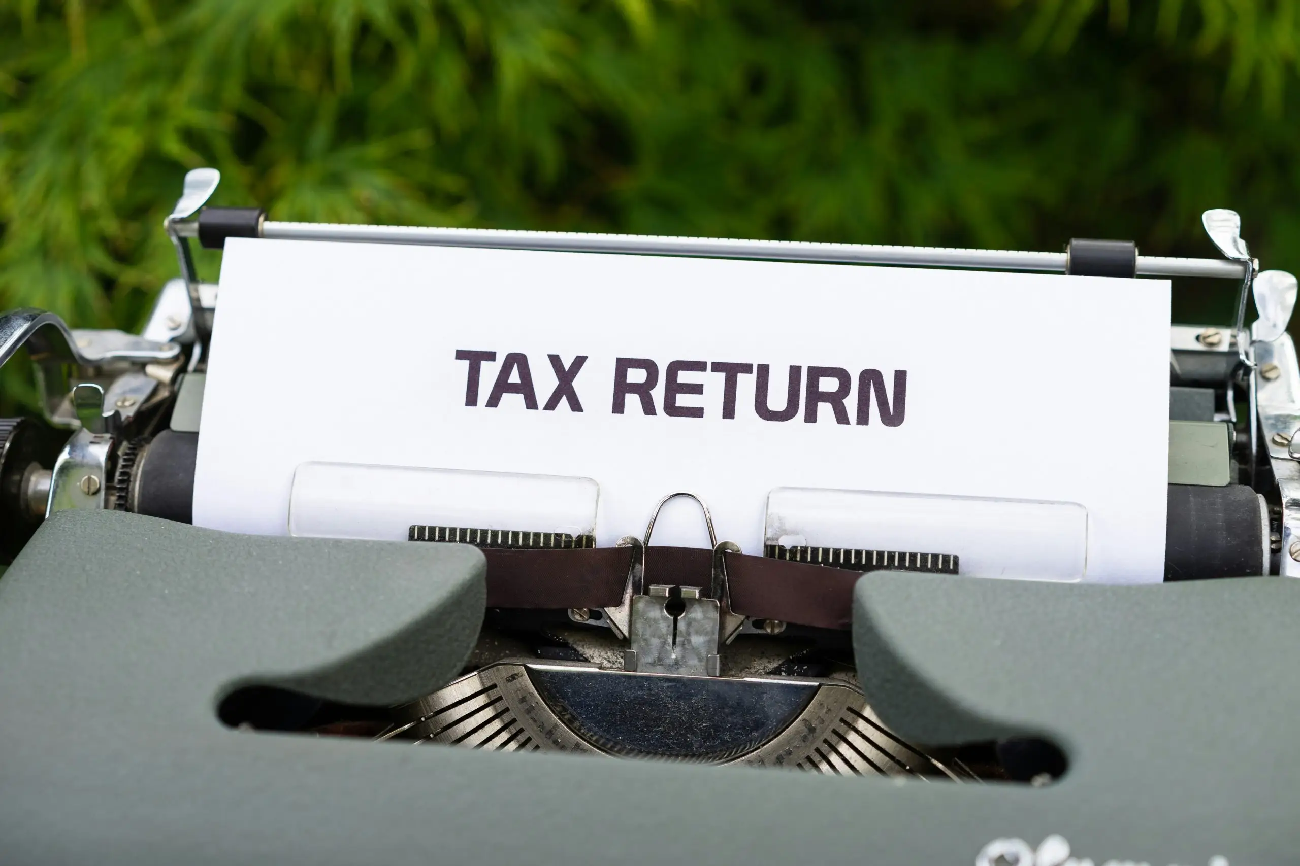 A typewriter with a tax return document inserted.